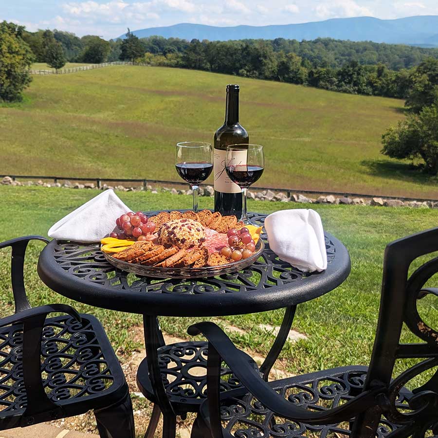 apero with a view package including charcuteri plate and wine overlooking the estate