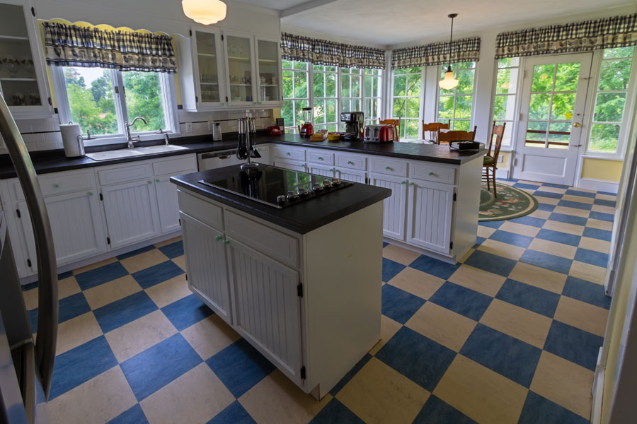 vine cottage kitchen with white cupboards and blue tile in natural bridge, virginia