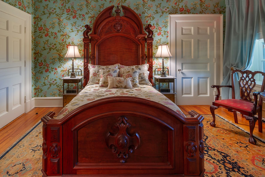 gunston guestroom antique wooden bed with nightstands at the inn at forest oaks in natural bridge virginia