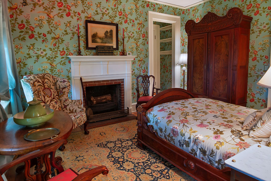 gunston guestroom with wood bed antique wardrobe and fireplace at the inn at forest oaks in natural bridge virginia