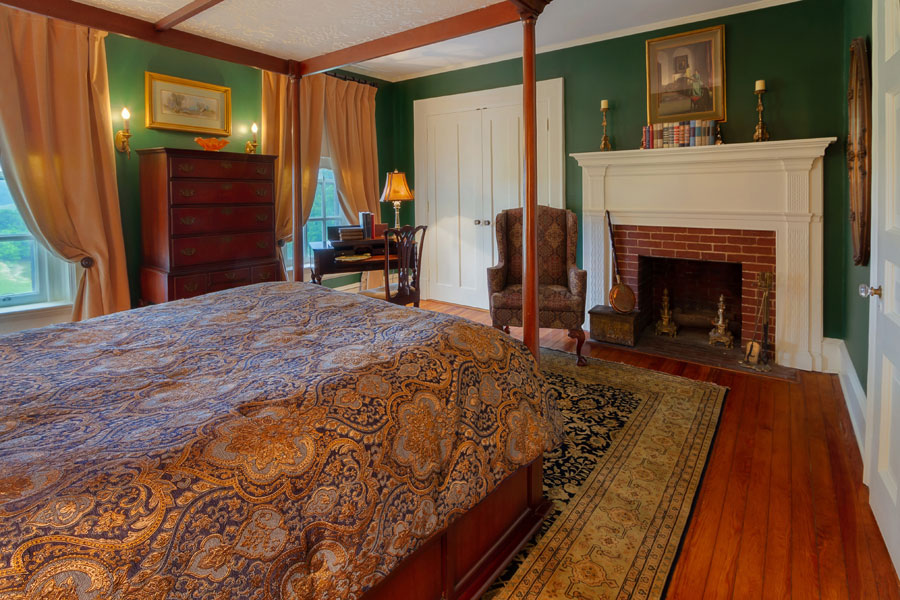 milburne room bed dresser and fireplace at the inn at forest oaks in natural bridge virginia