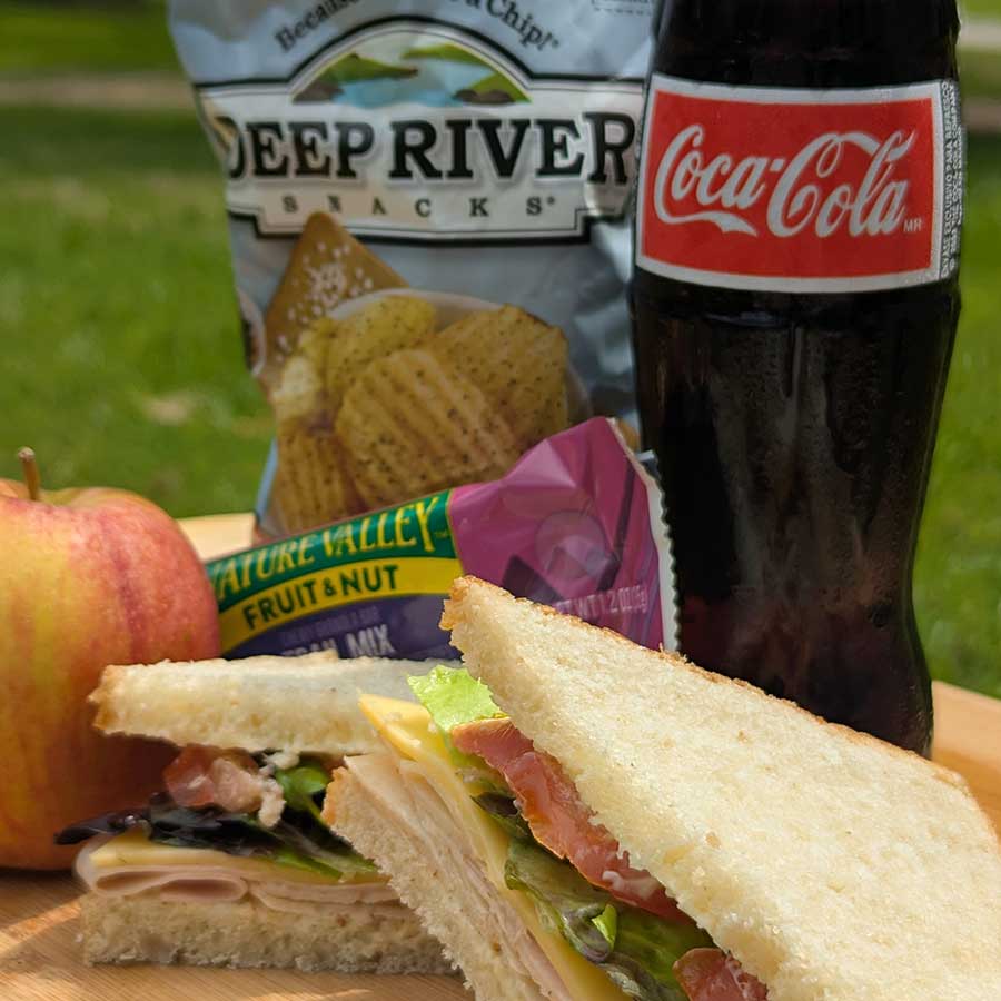 venture out package including bag lunch for two with sandwiches, chips, drink, and fruit